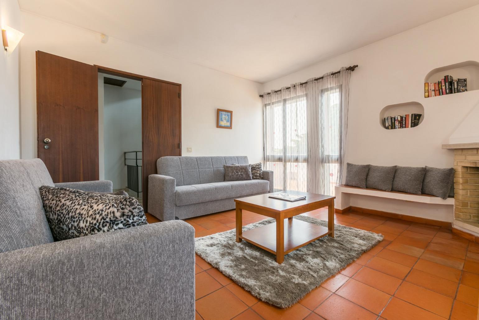 Living room with sofas, dining area, ornamental fireplace, WiFi internet, satellite TV, and DVD player