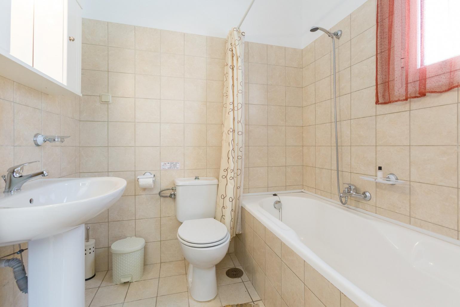 Bathroom with bath and overhead shower