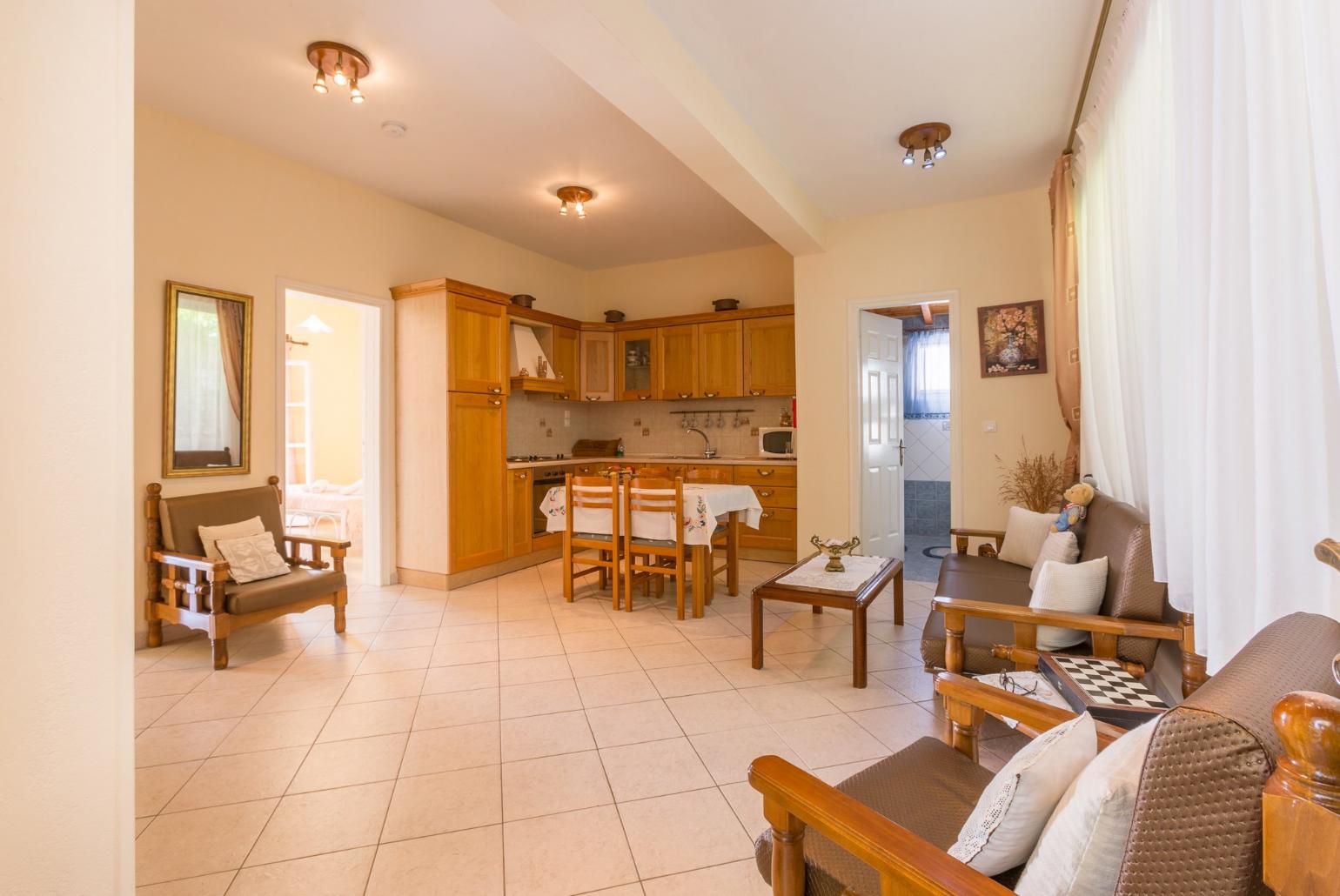 Living room with sofas, dining area, kitchen, WiFi internet, satellite TV, and DVD player