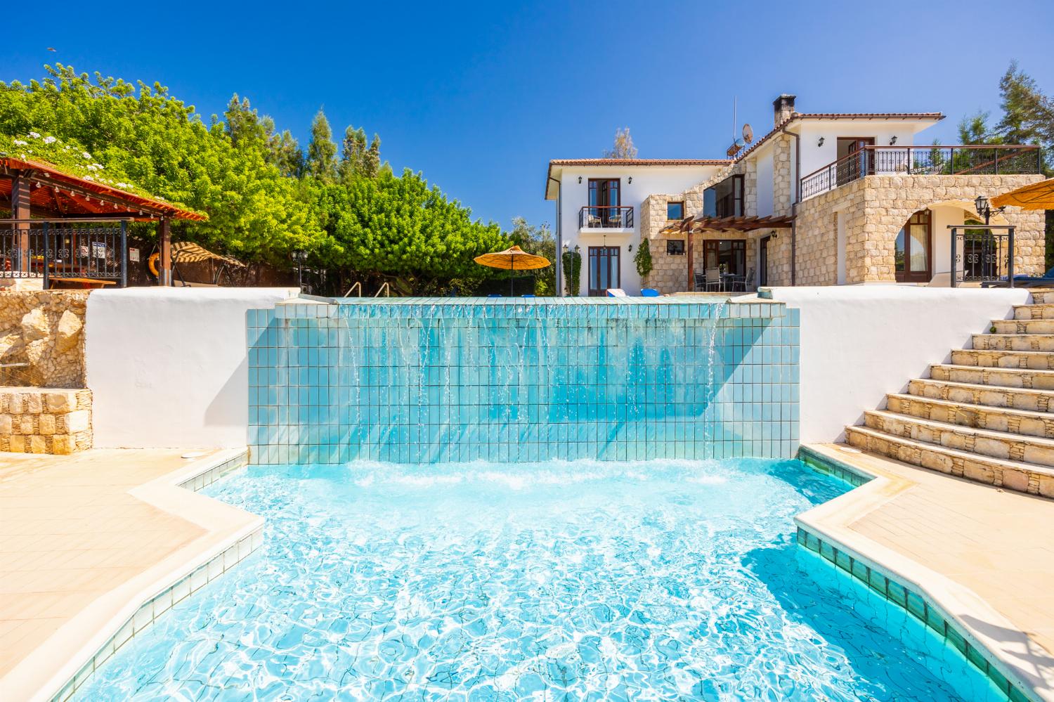,Beautiful villa with private pool, terrace, and garden with sea views