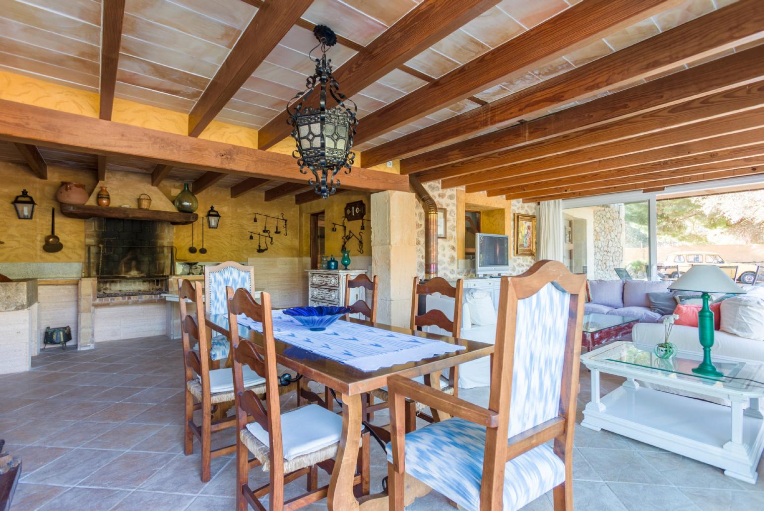 Living room with sofas, dining area, ornamental fireplace, WiFi internet, satellite TV, DVD player, and terrace access