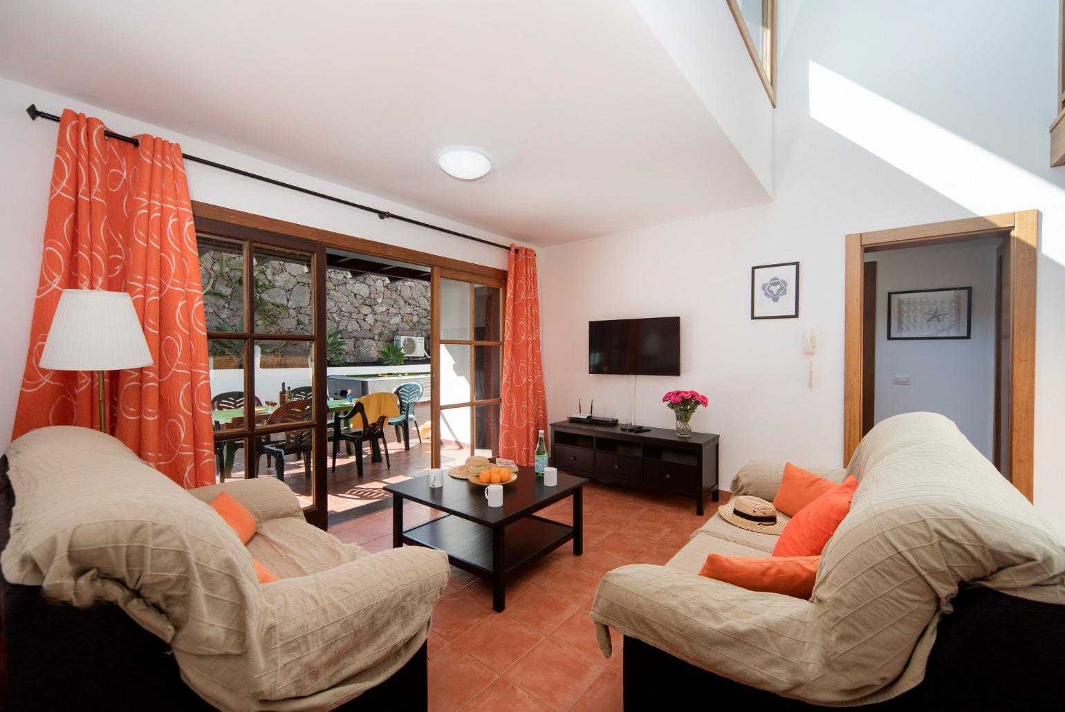 Living room with sofas, WiFi internet, satellite TV, DVD player and terrace access