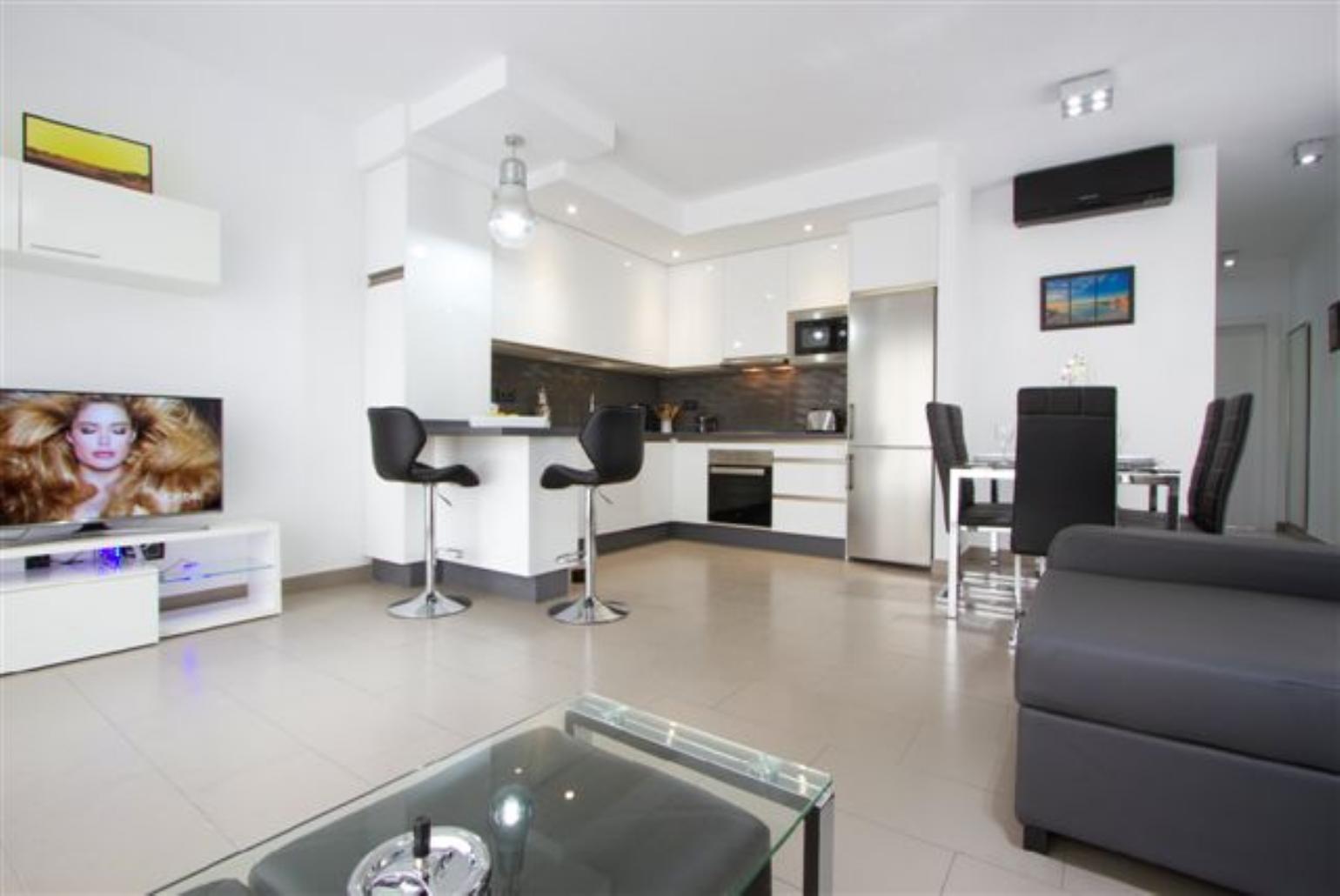 Open plan living area with WiFi, TV, DVD player with terrace access