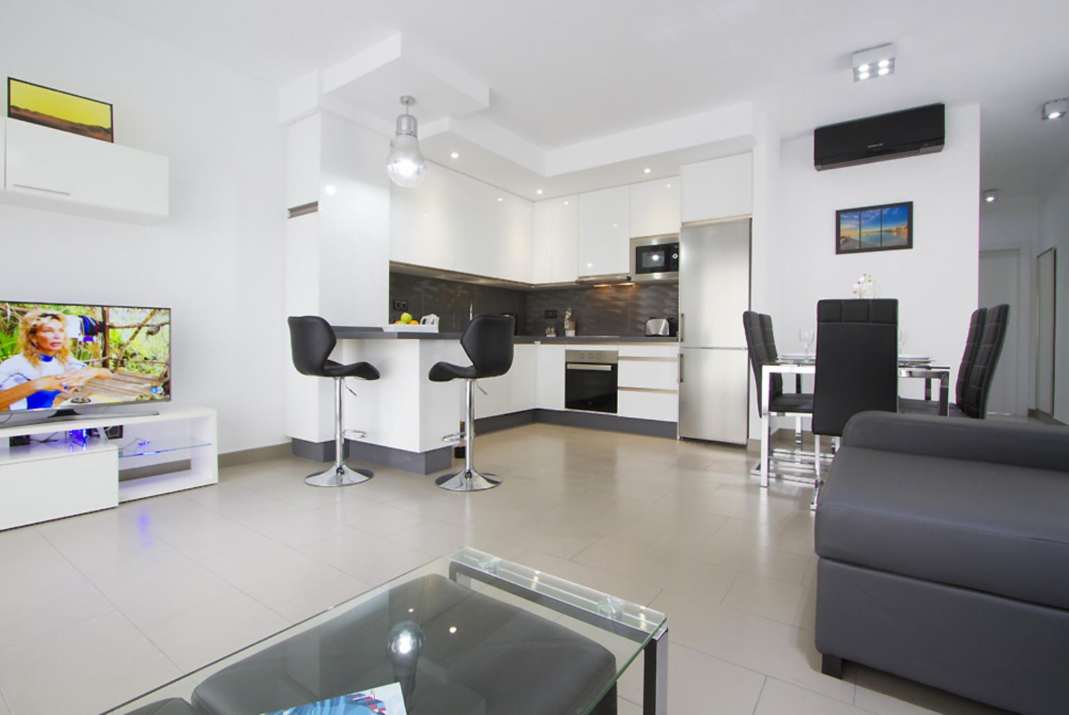 Open plan living area with WiFi, TV, DVD player with terrace access