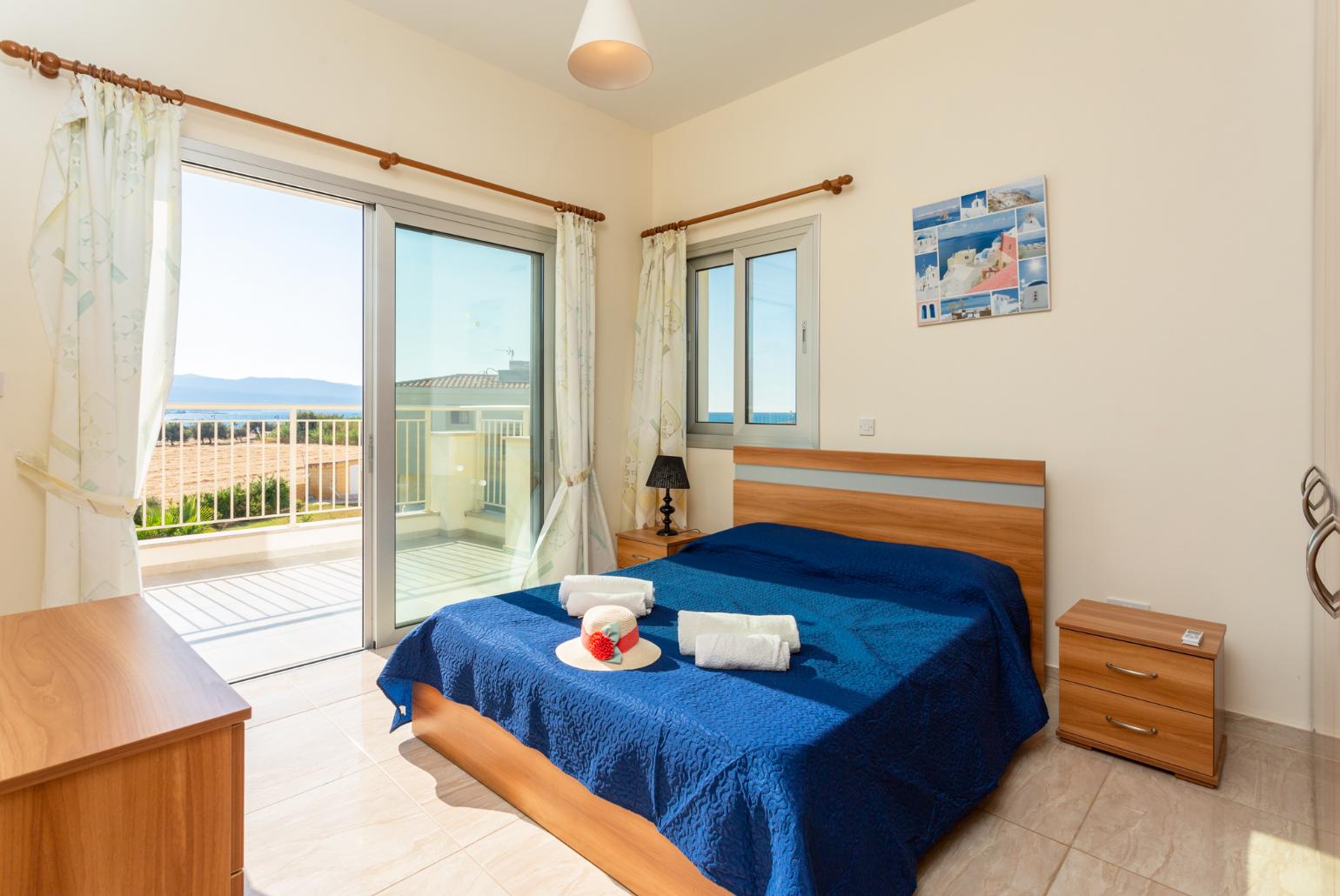 Double bedroom with en suite bathroom, A/C, and upper terrace access with sea views