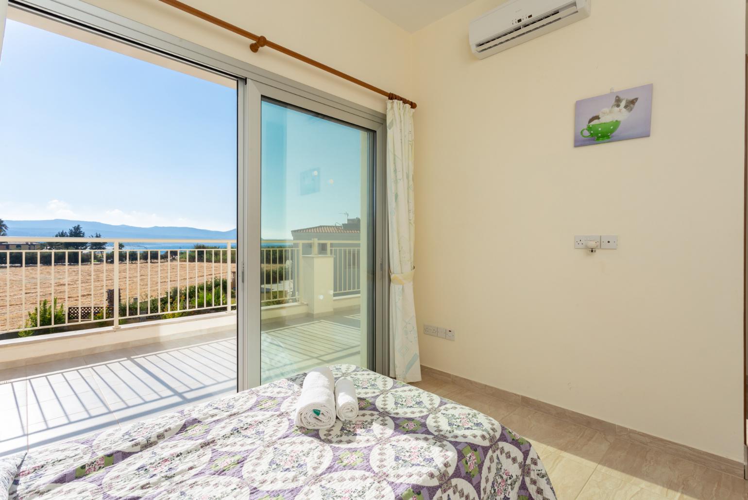 Twin bedroom with en suite bathroom, A/C, and upper terrace access with sea views