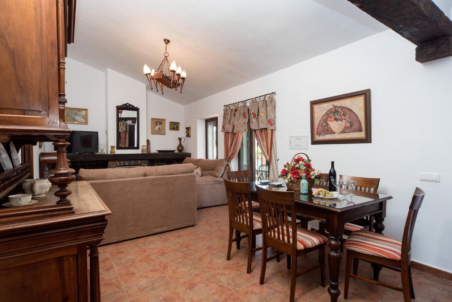 Living room with sofas, dining area, ornamental fireplace, A/C, WiFi internet, satellite TV, DVD player, and terrace access