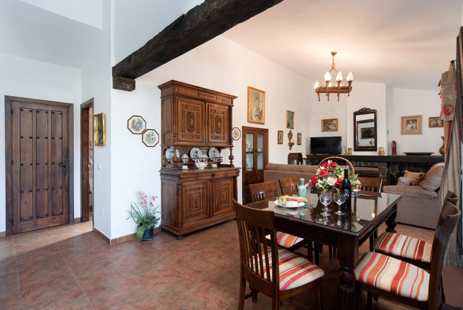 Living room with sofas, dining area, ornamental fireplace, A/C, WiFi internet, satellite TV, DVD player, and terrace access