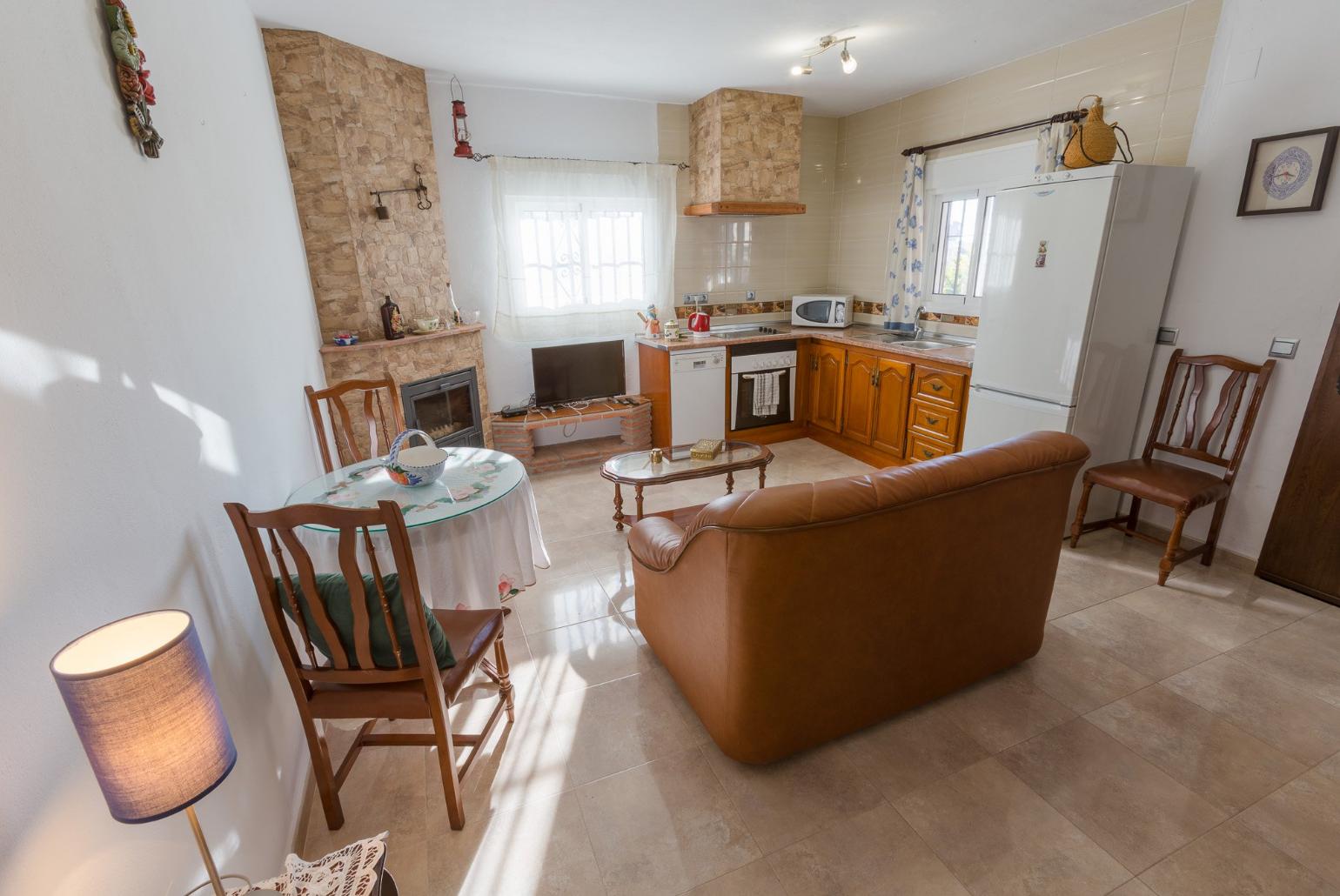 Living room has sofas, WiFi Internet, Satellite TV, DVD player, dining area and ornamental fire place and Equipped kitchen