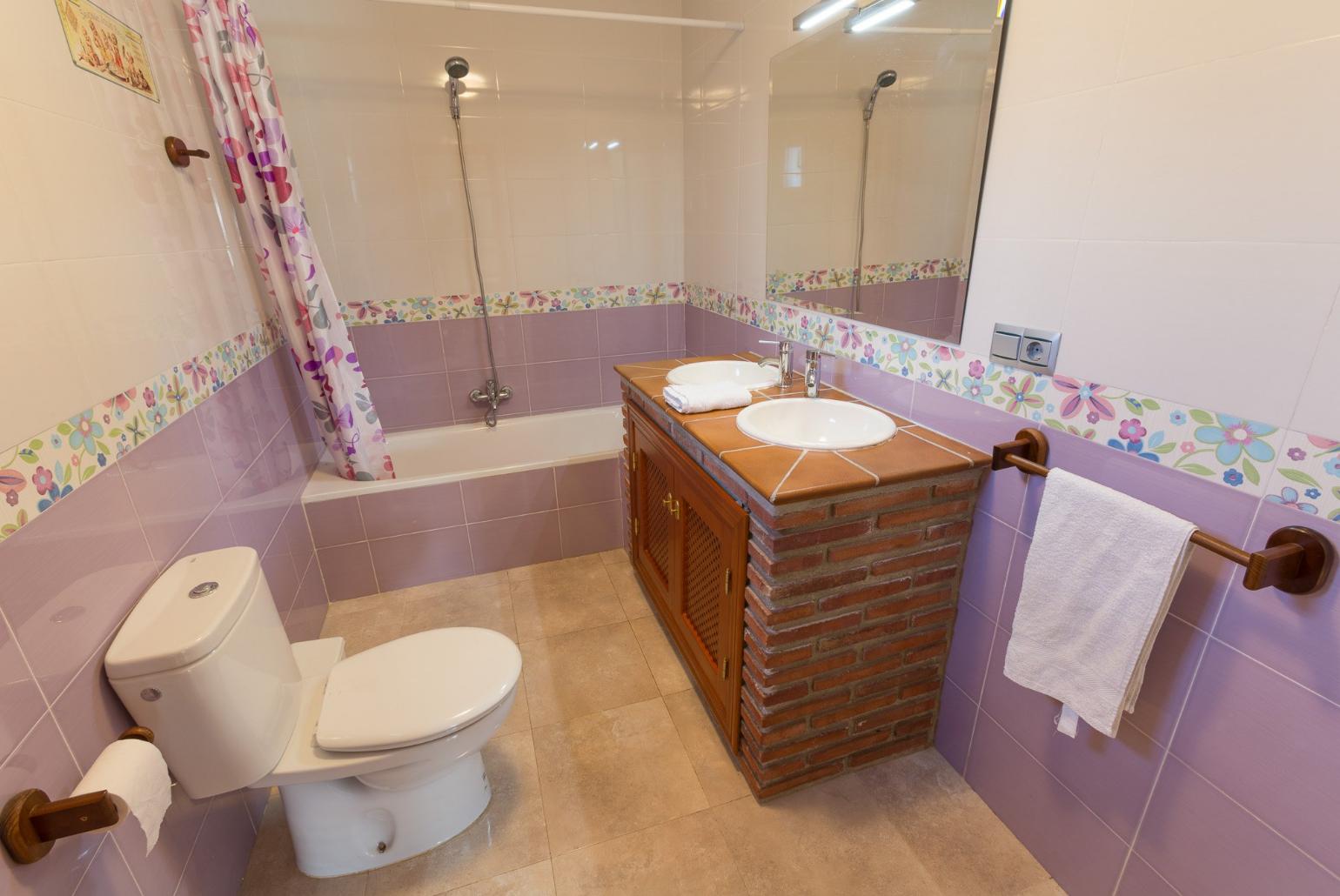 Family bathroom, bath with shower. W/C.