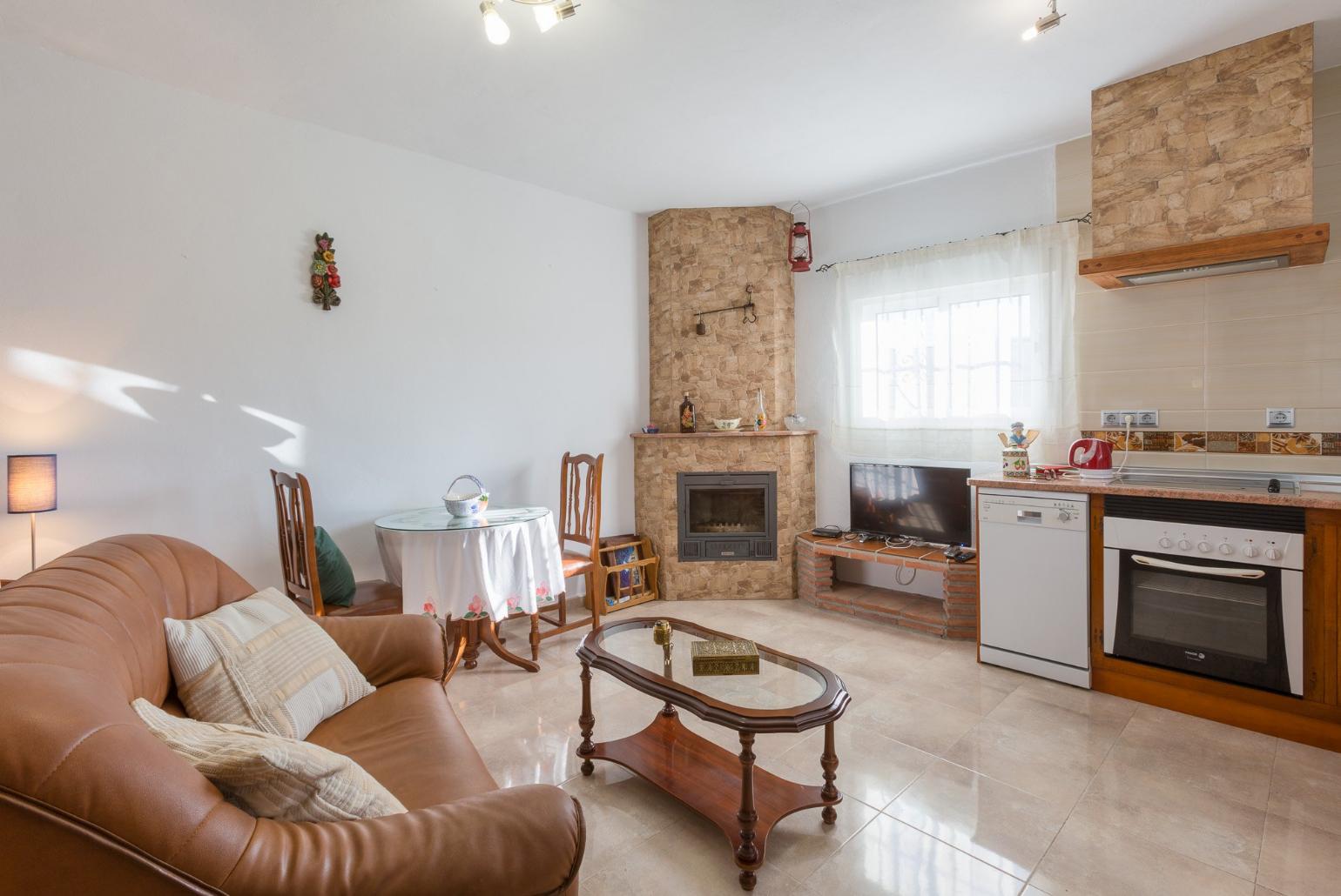 Living room has sofas, WiFi Internet, Satellite TV, DVD player, dining area and ornamental fire place and Equipped kitchen