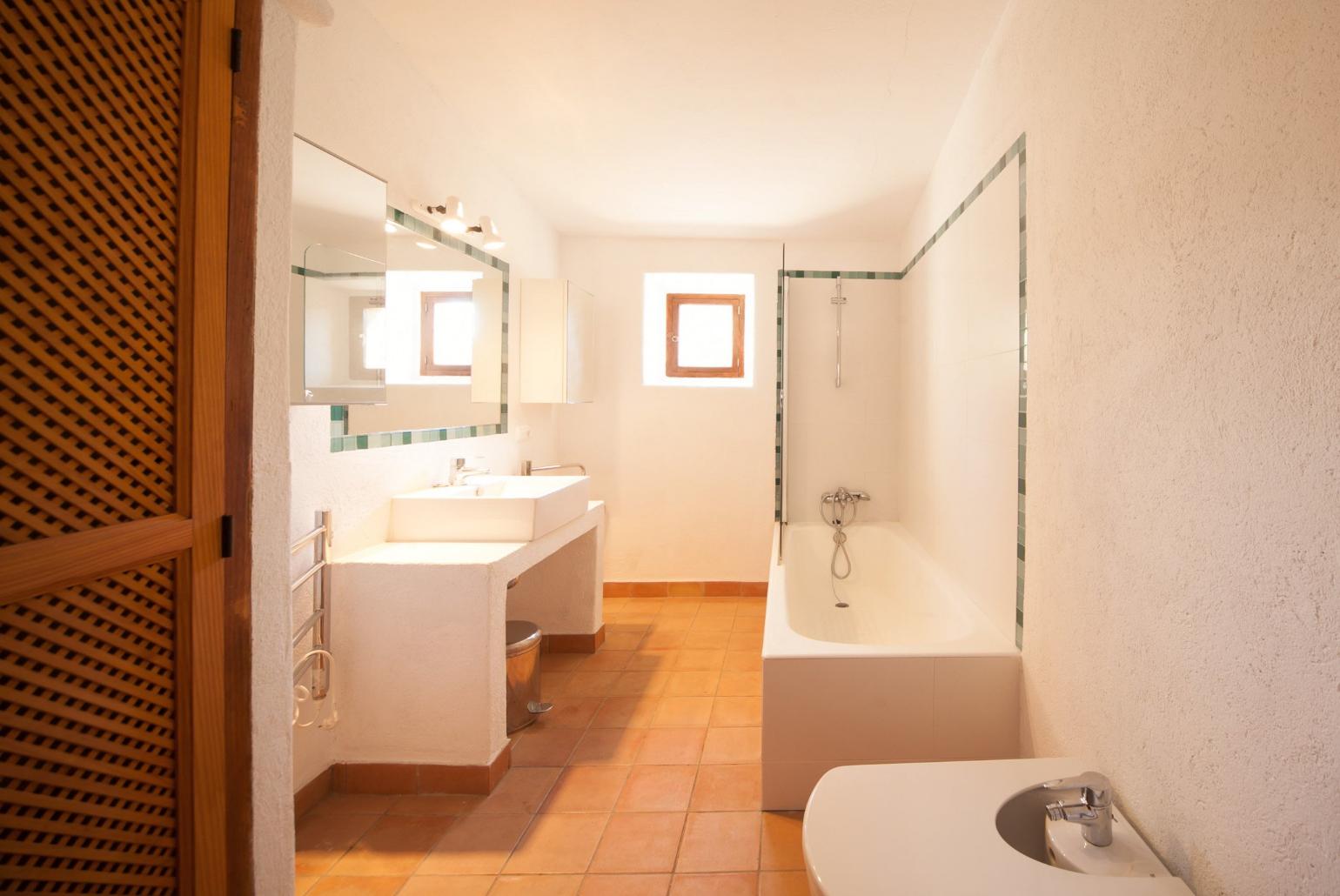 Bathroom with bath and overhead shower