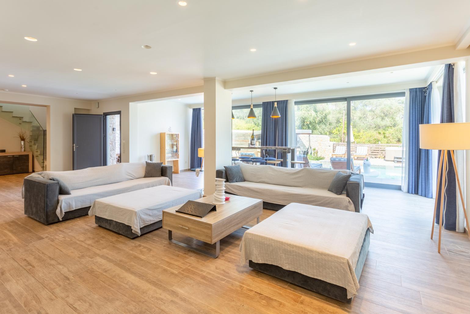 Living room with sofas, dining area, ornamental fireplace, WiFi internet, satellite TV, and terrace access