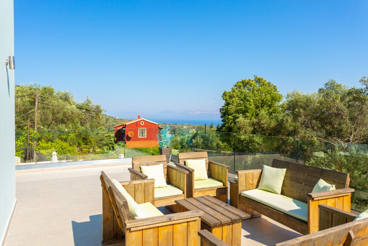 Upper terrace with outdoor seating and sea views