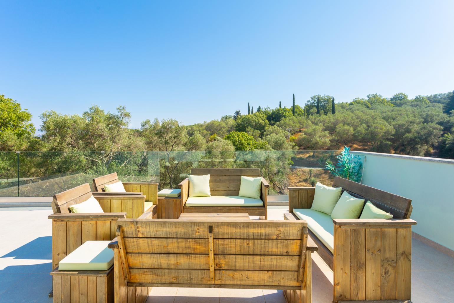 Upper terrace with outdoor seating and sea views