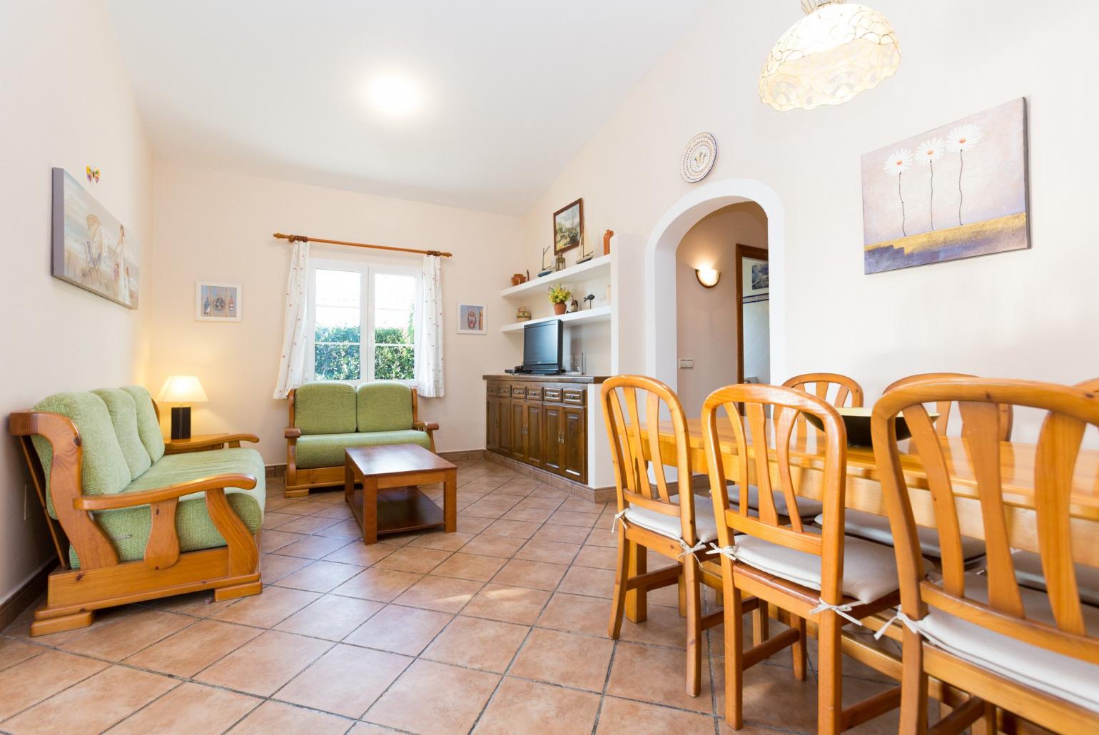 Living room with sofas, WiFi Internet, Satellite TV, DVD player and dining area.