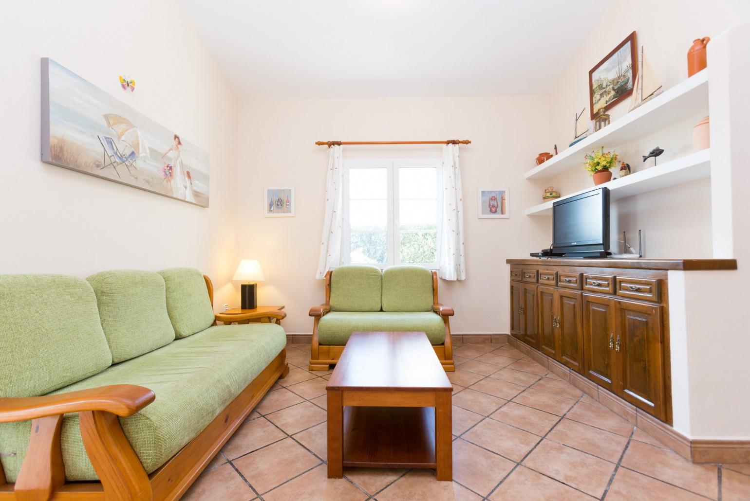 Living room with sofas, WiFi Internet, Satellite TV, DVD player and dining area.