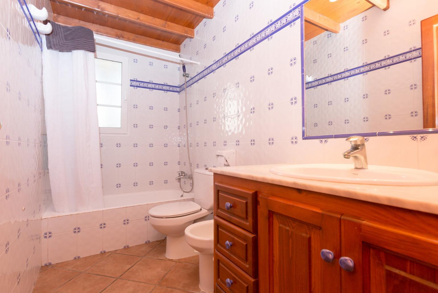 Bathroom with bath overhead shower