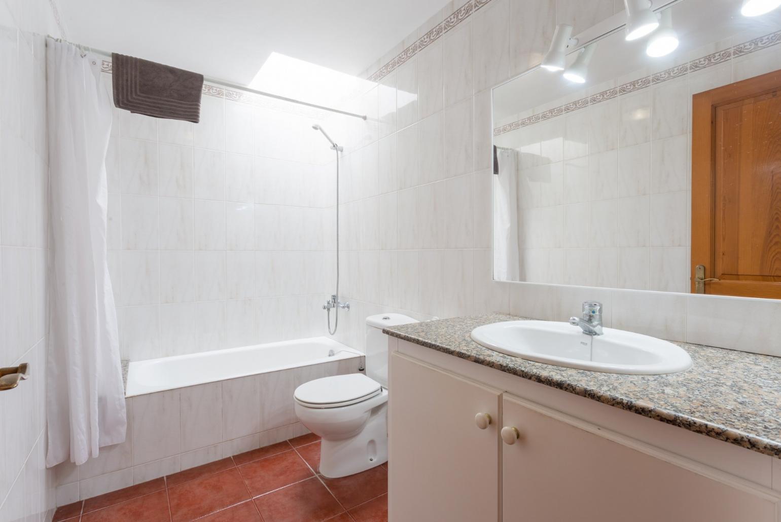 Family bathroom with bath and overhead shower