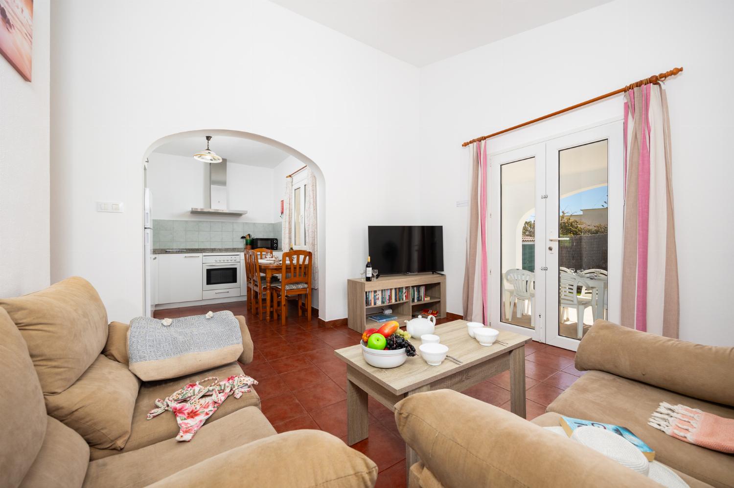 Open-plan living room with sofas, dining area, kitchen, WiFi internet, and satellite TV