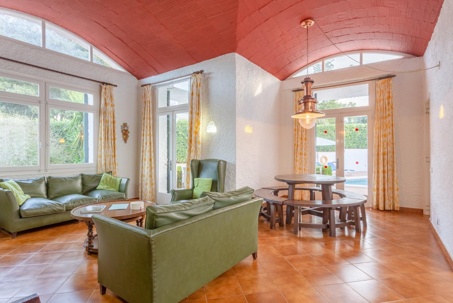 Living room with sofas, dining area, ornamental fireplace, WiFi internet, satellite TV, DVD player, and terrace access