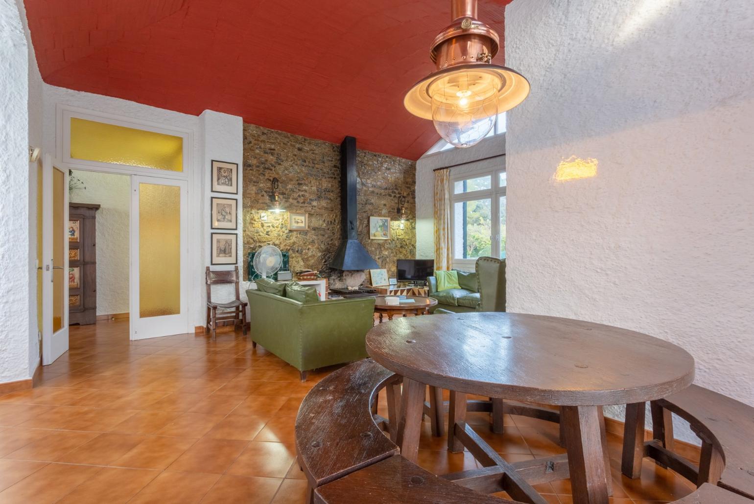 Living room with sofas, dining area, ornamental fireplace, WiFi internet, satellite TV, DVD player, and terrace access