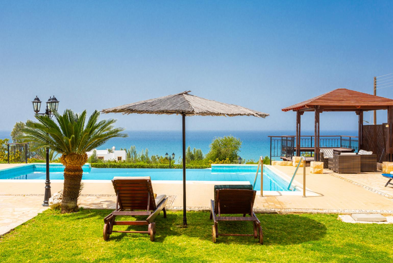 Private infinity pool, terrace, and garden with panoramic sea views