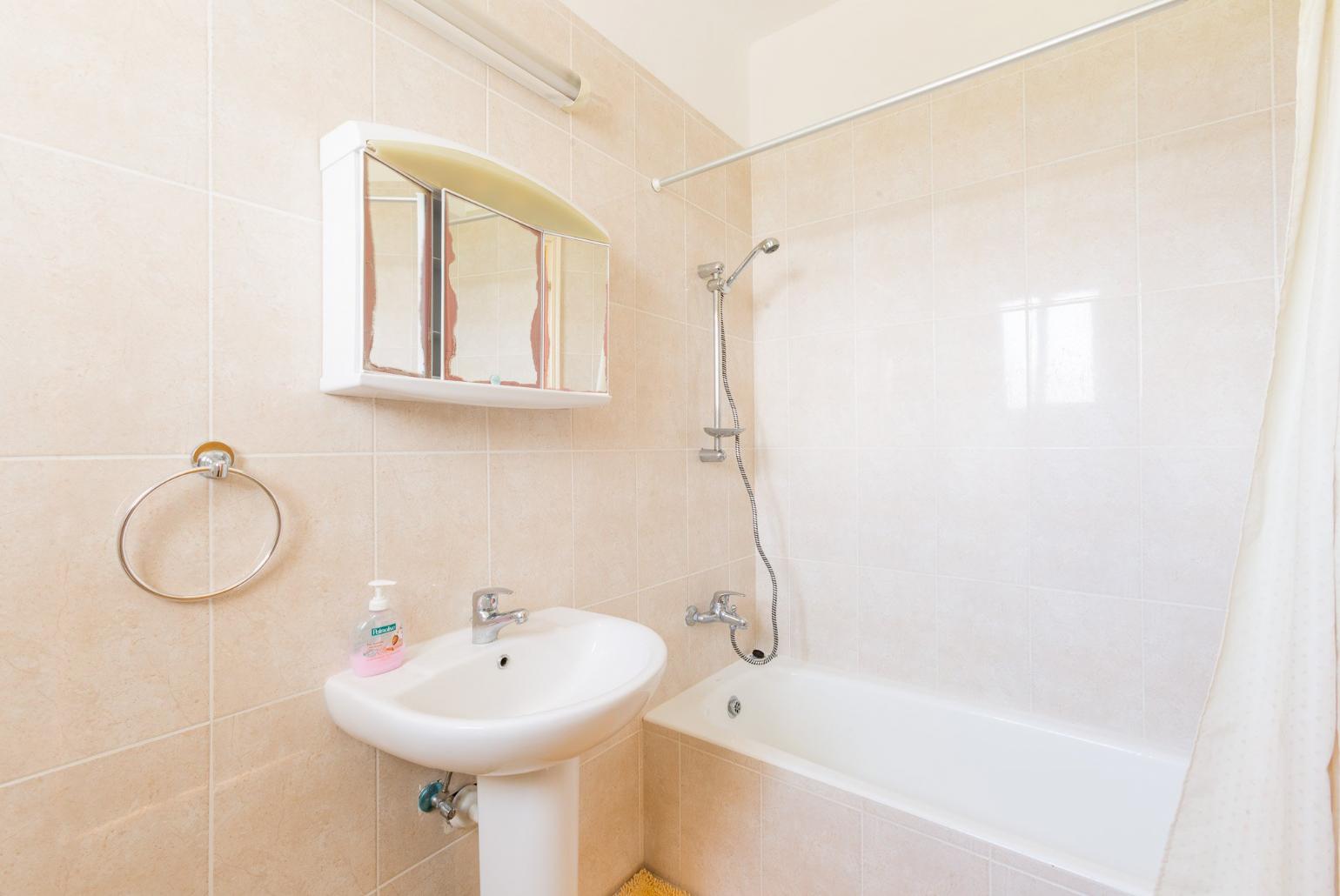 Bathroom with bath and shower
