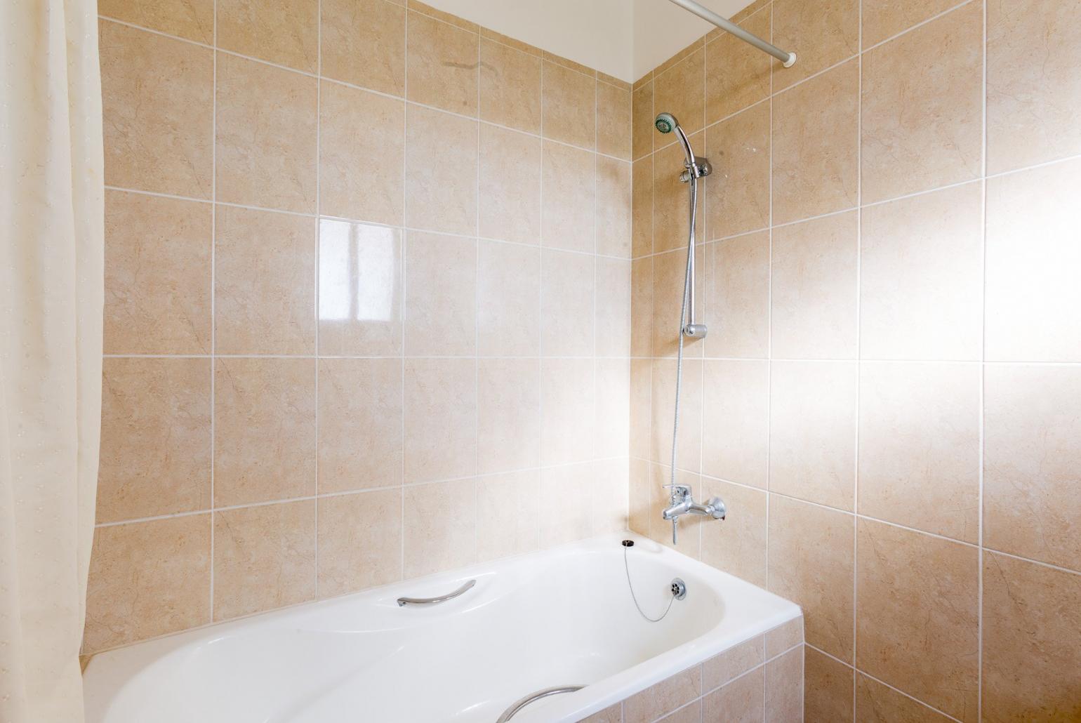 Bathroom with bath and shower