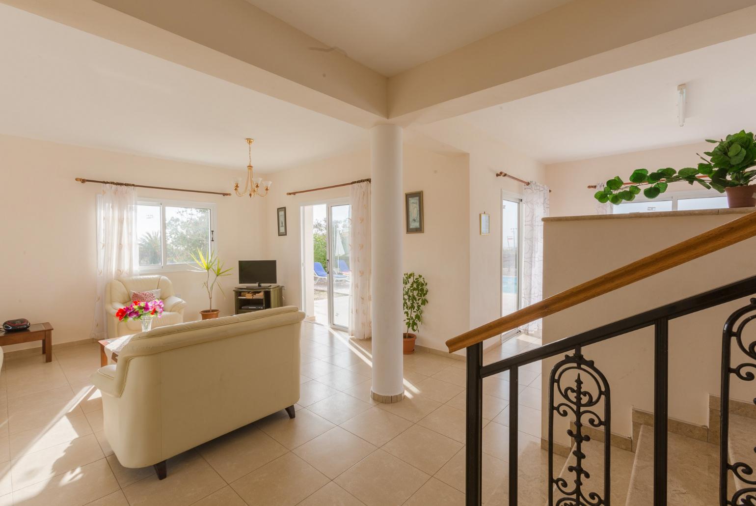 Open-plan living room with sofas, dining area, kitchen, WiFi internet, satellite TV, DVD player, and terrace access