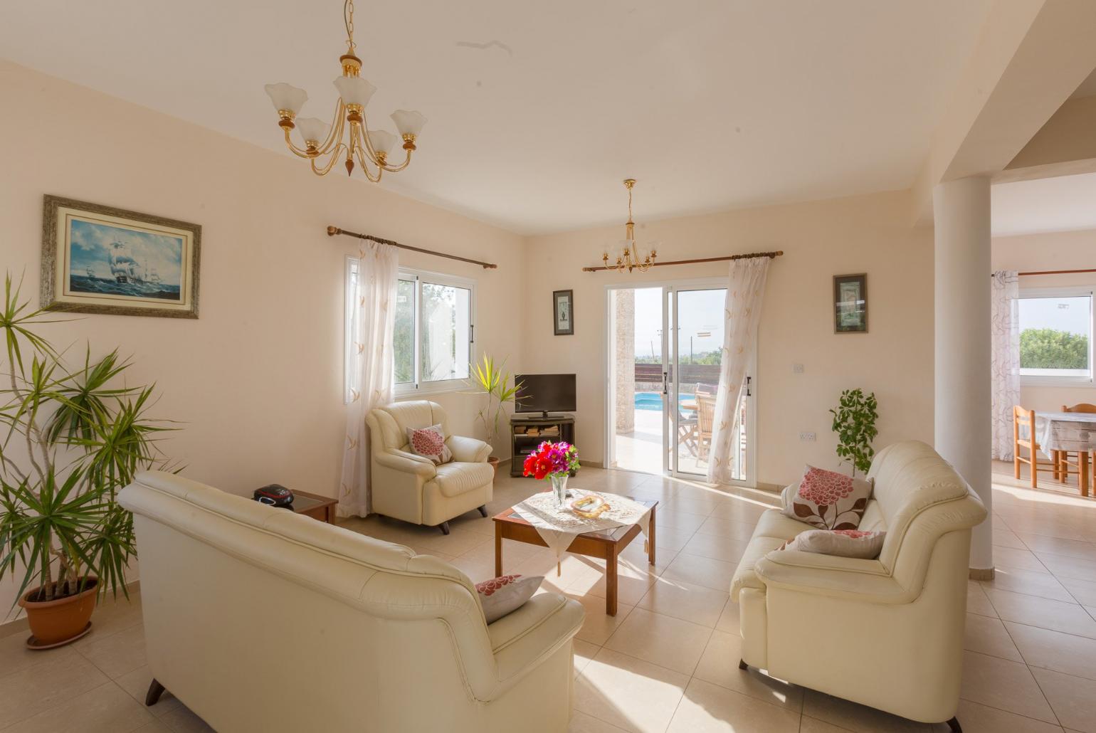 Open-plan living room with sofas, dining area, kitchen, WiFi internet, satellite TV, DVD player, and terrace access