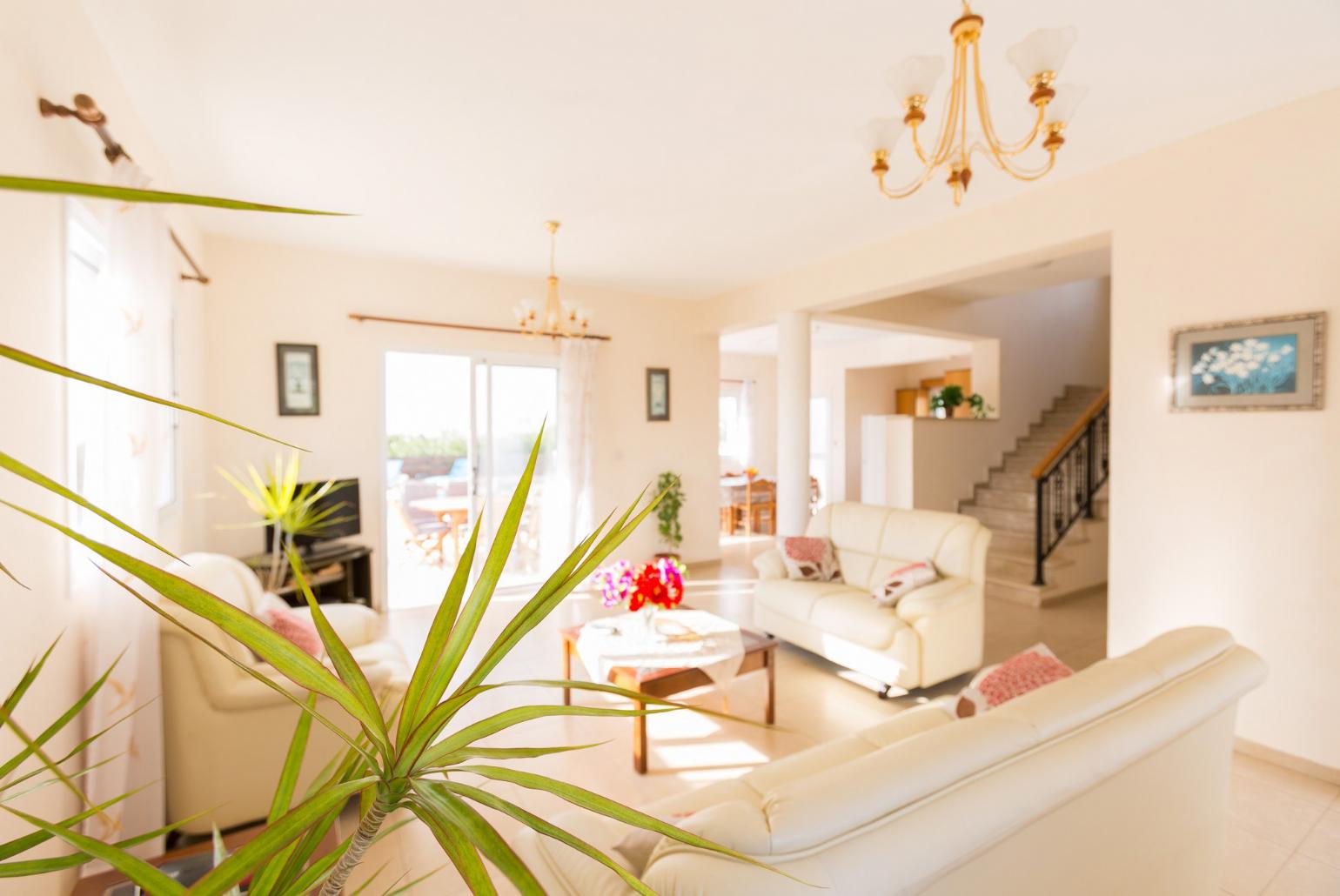Open-plan living room with sofas, dining area, kitchen, WiFi internet, satellite TV, DVD player, and terrace access