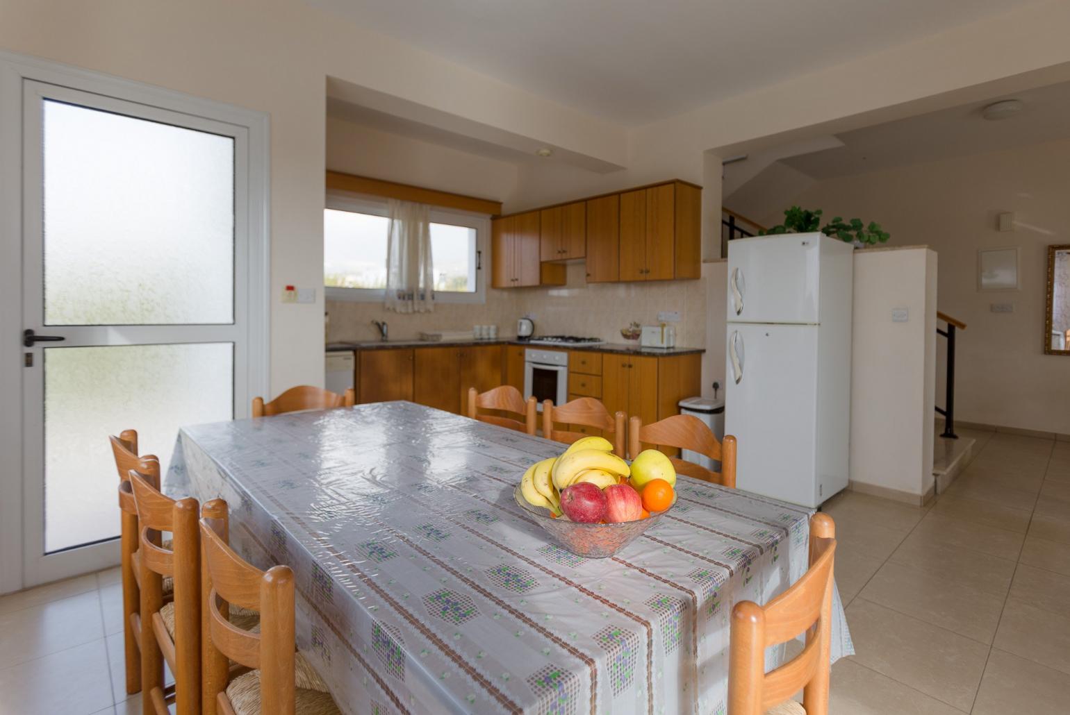 Open-plan living room with sofas, dining area, kitchen, WiFi internet, satellite TV, DVD player, and terrace access