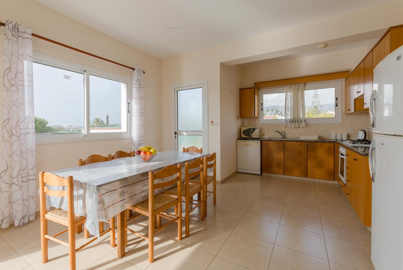 Open-plan living room with sofas, dining area, equipped kitchen, WiFi internet, satellite TV, DVD player, and terrace access