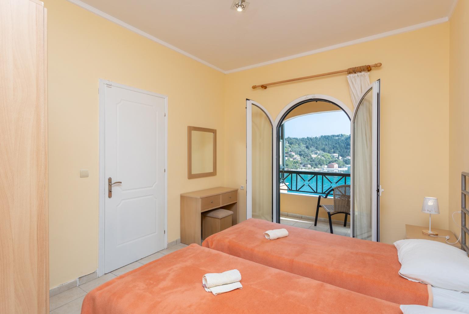 Twin bedroom with A/C, sea views, and terrace access