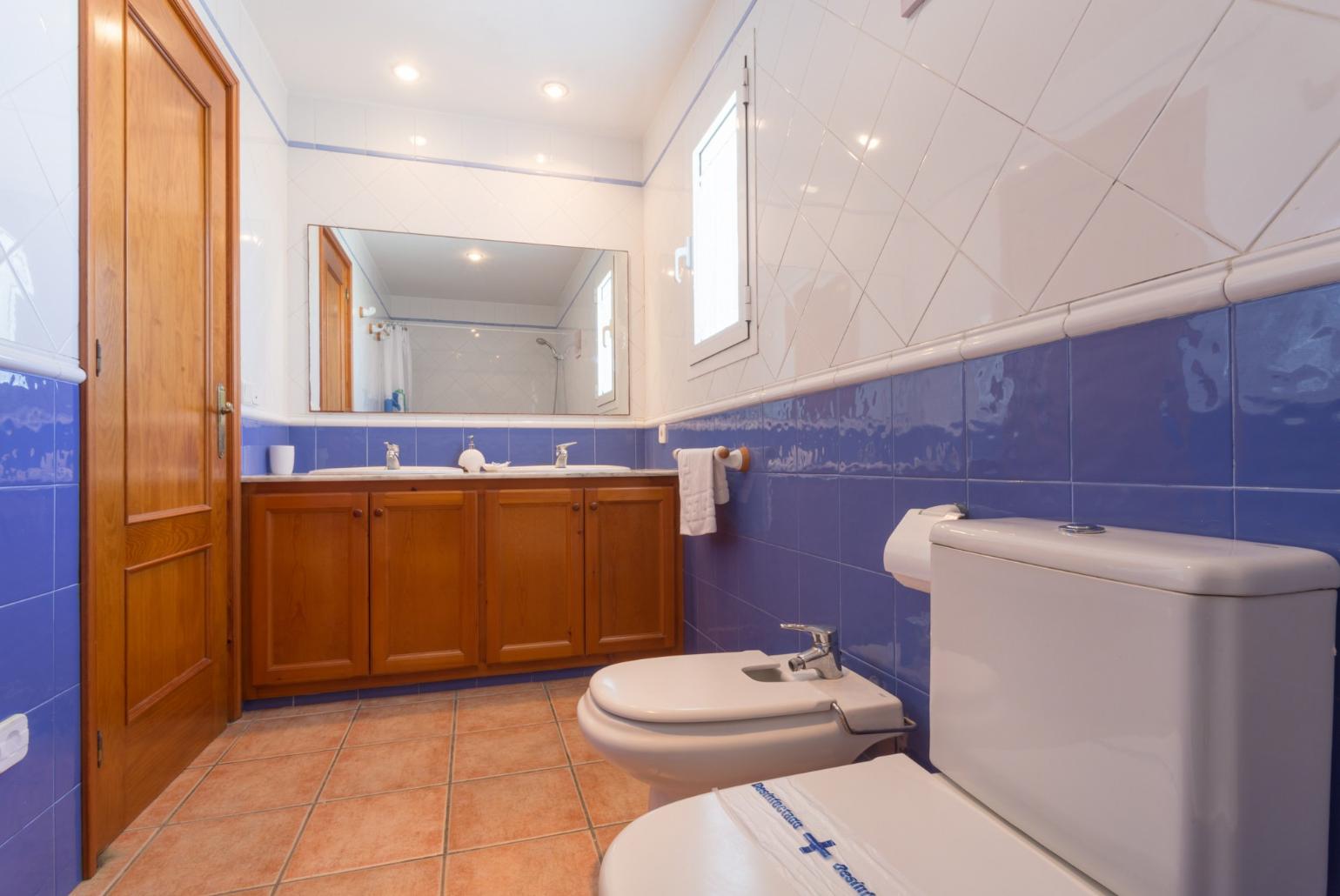 En suite bathroom with bath and overhead shower