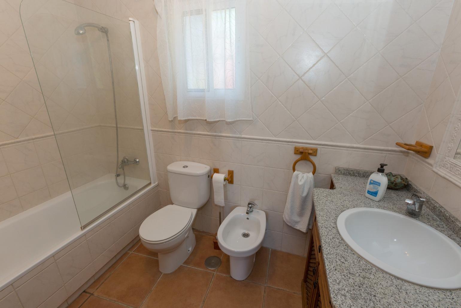 Family bathroom, bath with shower.