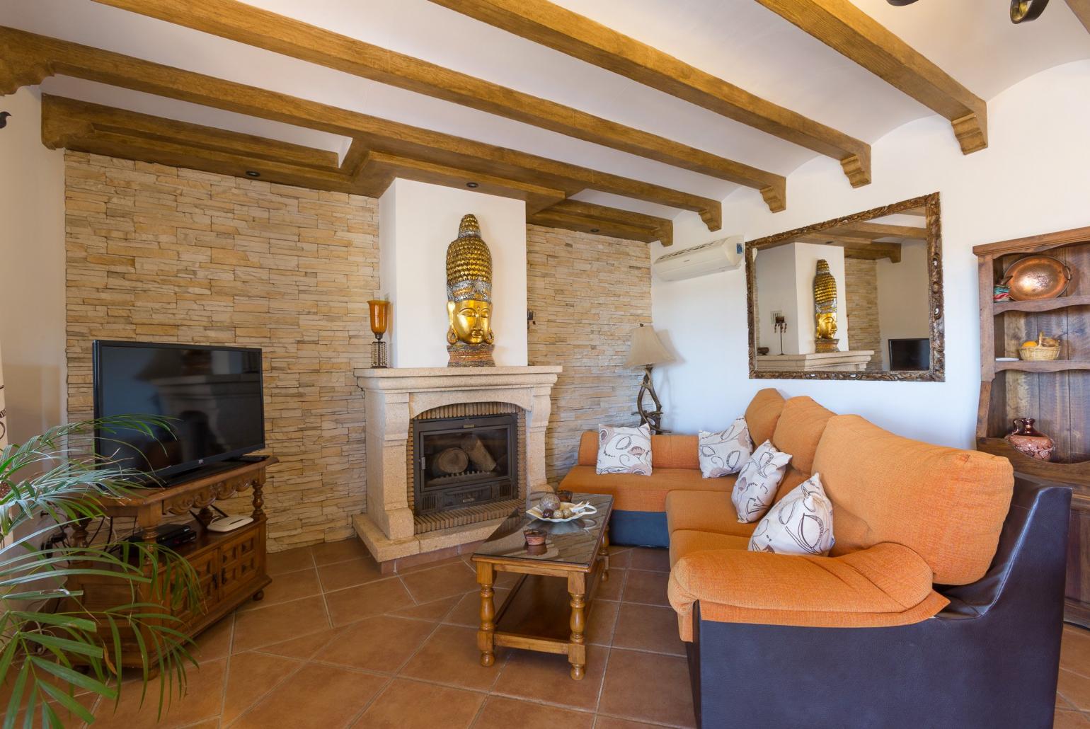 Living room with sofas, WiFi Internet, Satellite TV, DVD player, dining area and ornamental fire place.