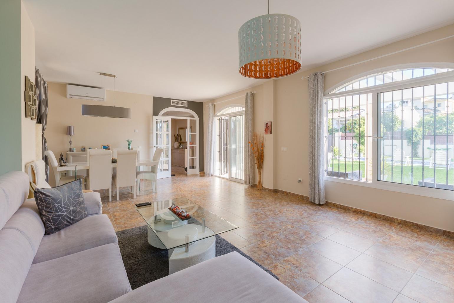 Open-plan living room with has sofas, WiFi Internet, Satellite TV, DVD player, dining area and ornamental fire place.