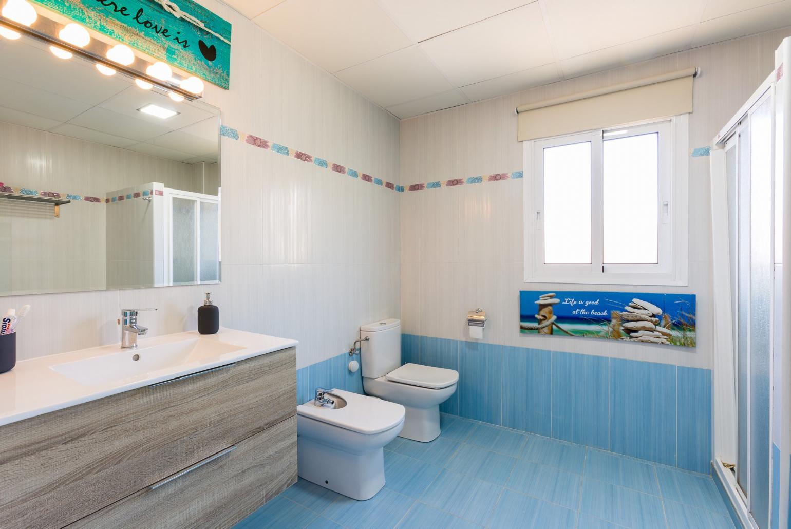 An en suite bathroom with shower. W/C.