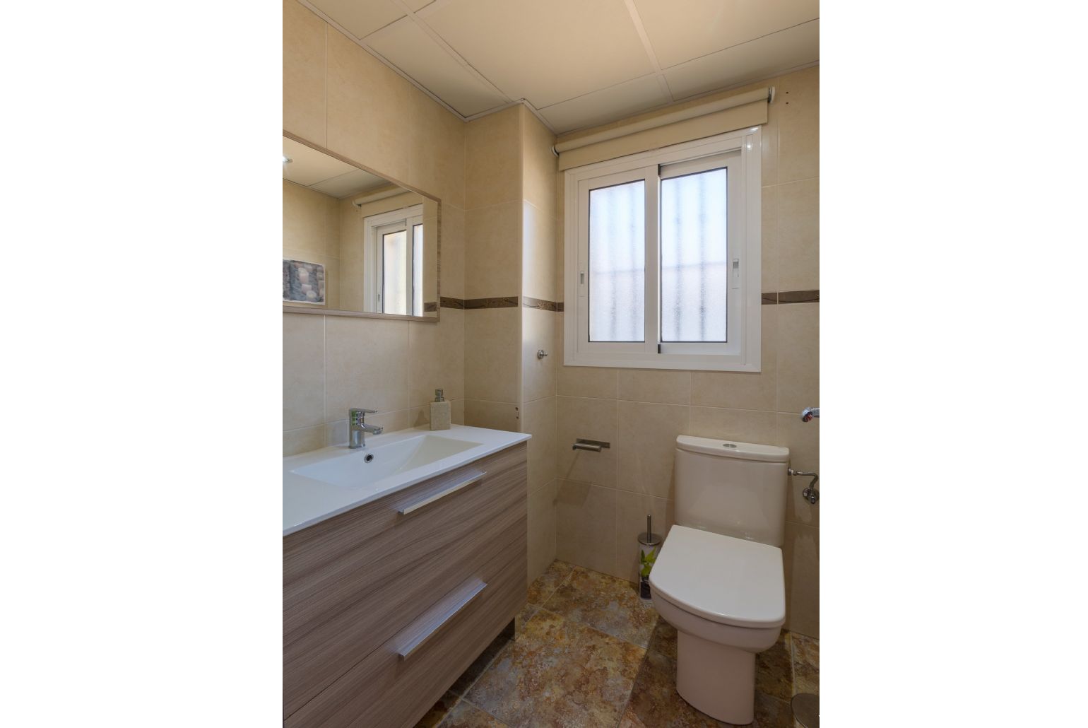 Family bathroom, bath with shower. W/C.