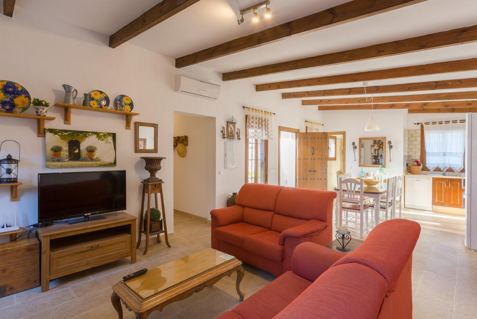 Living room with A/C, sofas, dining area, kitchen, ornamental fireplace, WiFi internet, satellite TV, and pool terrace access
