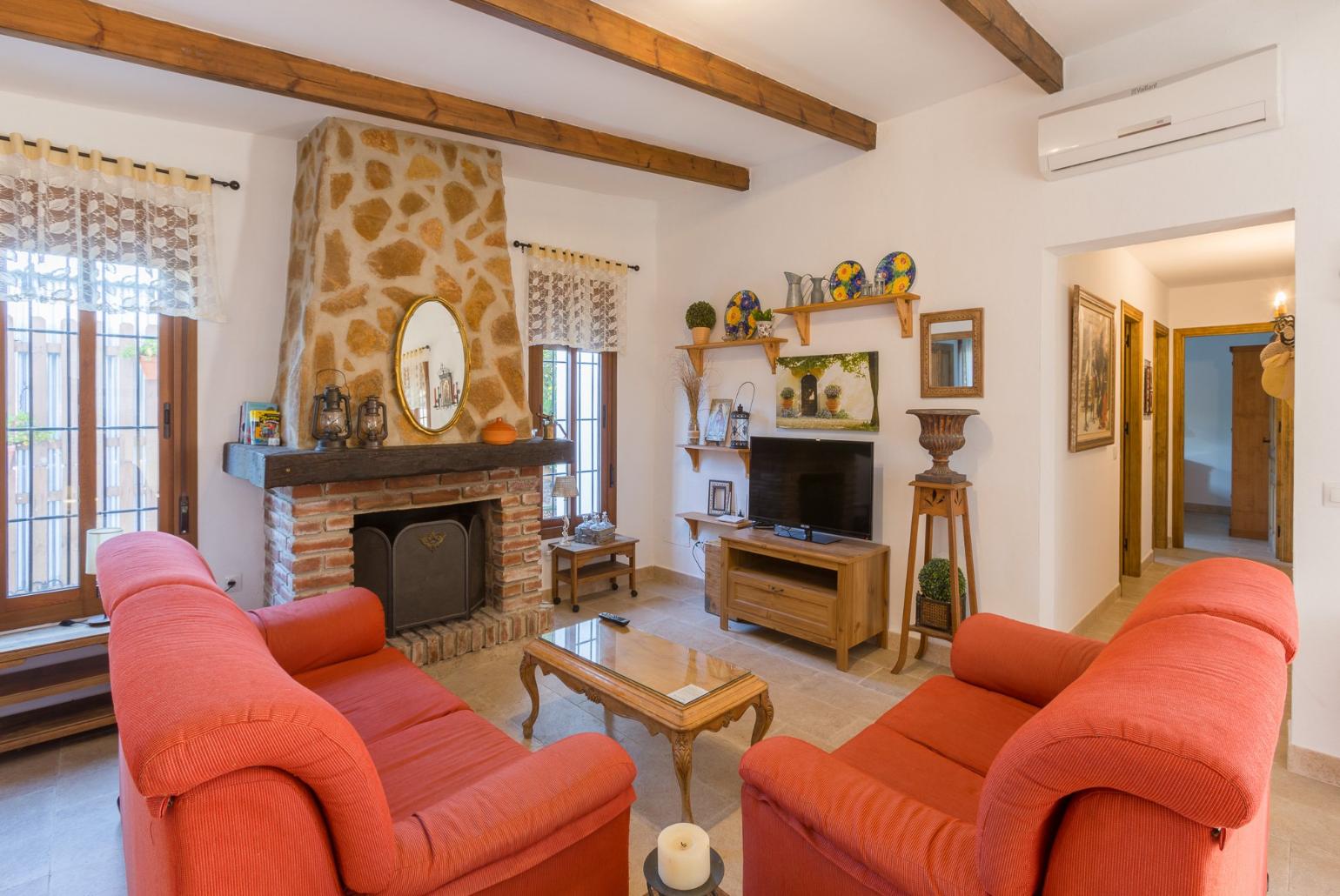 Living room with A/C, sofas, dining area, kitchen, ornamental fireplace, WiFi internet, satellite TV, and pool terrace access