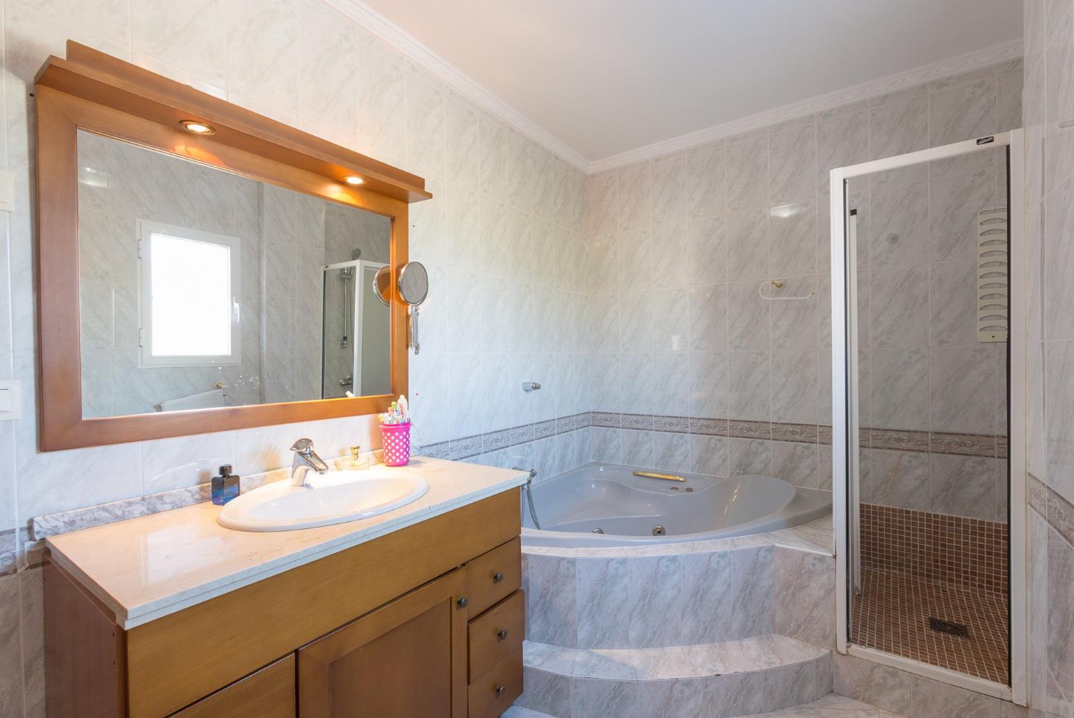 Bathroom with bathtub and shower