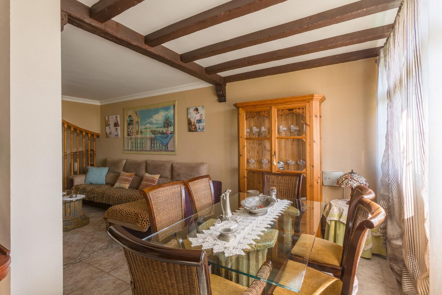 Open-plan living room with ornamental fireplace, TV and dining area