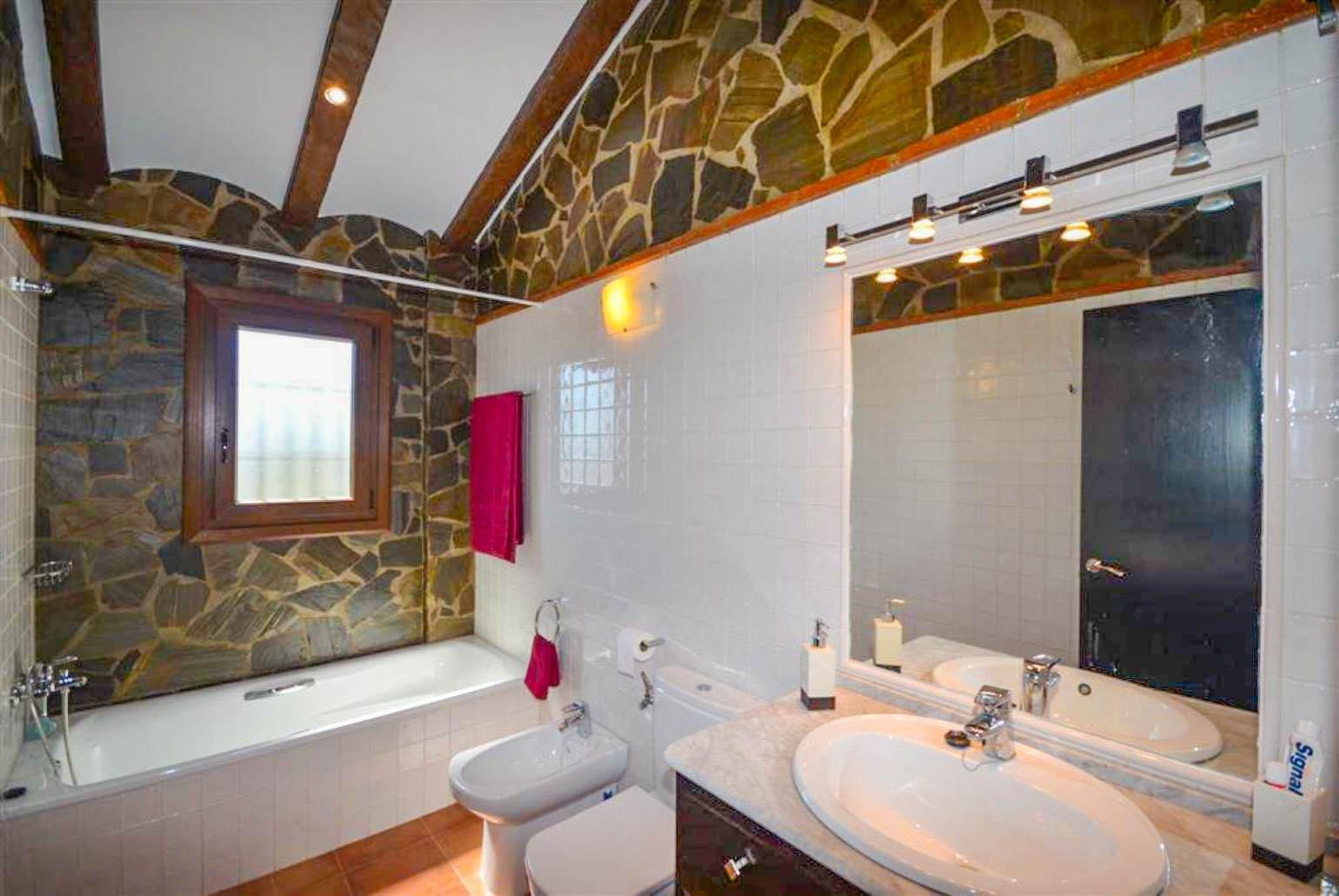 En suite bathroom, bath with shower. W/C.