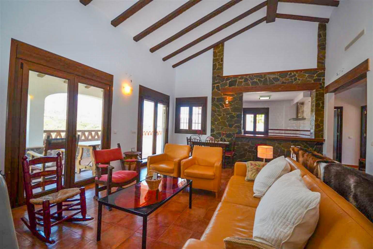 Open-plan living room with sofas, WiFi Internet, Satellite TV, DVD player, dining area and ornamental fire place.