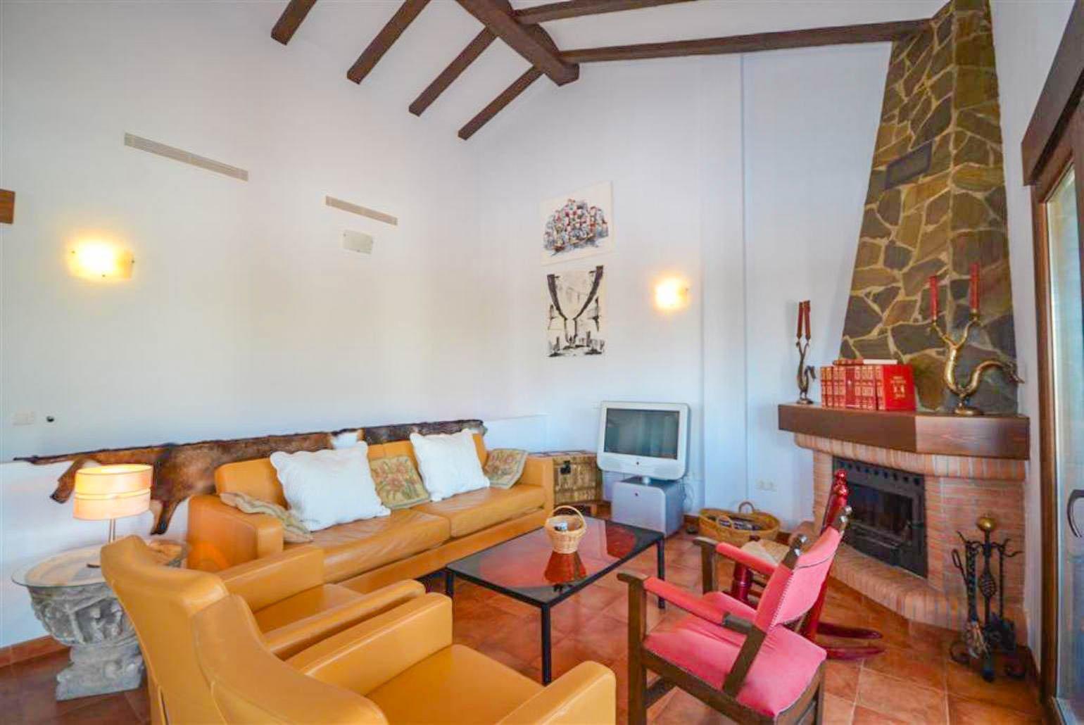 Open-plan living room with sofas, WiFi Internet, Satellite TV, DVD player, dining area and ornamental fire place.