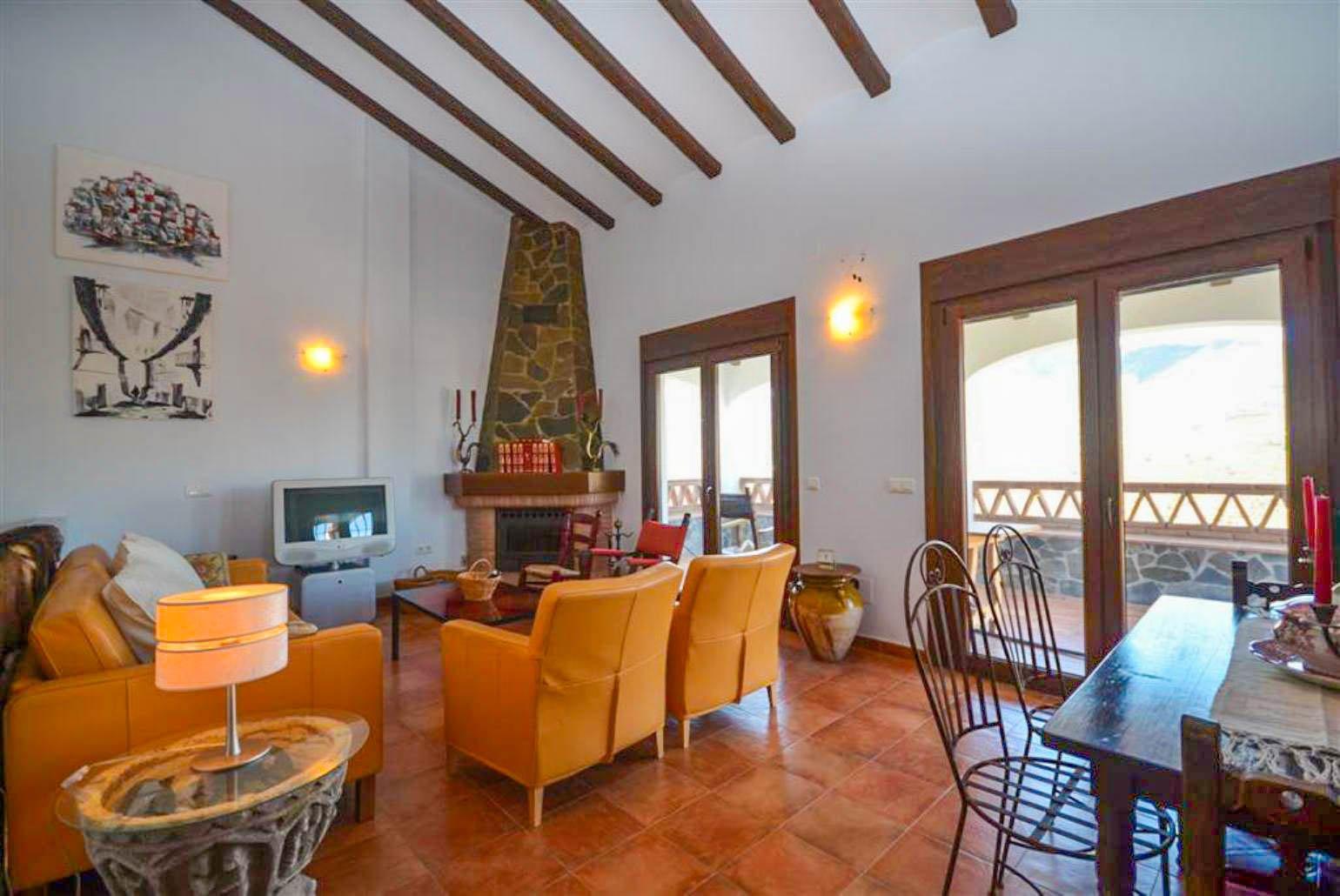 Open-plan living room with sofas, WiFi Internet, Satellite TV, DVD player, dining area and ornamental fire place.