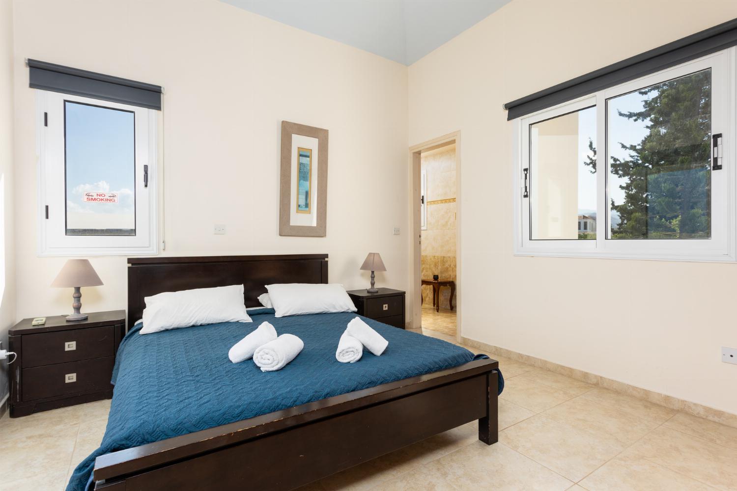 Double bedroom with en suite bathroom, A/C, and balcony access